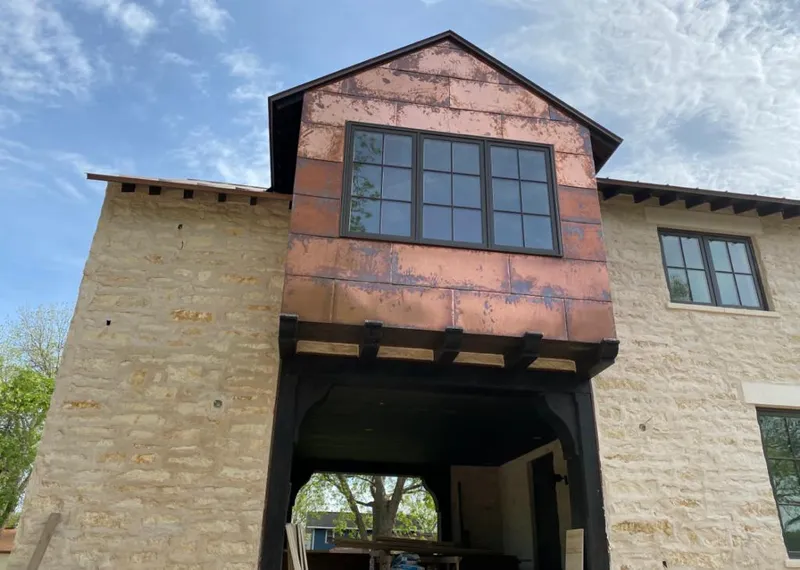 Copper metal panel facade on a stone building for Skylight Installation in Summit